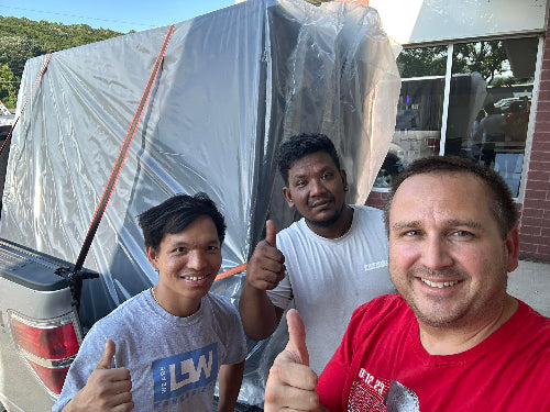 Happy customers giving thumbs up with their mattress purchase and taking home same day