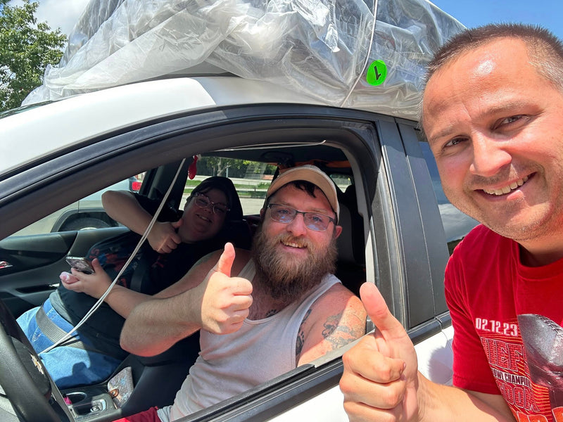 Happy Customers giving the thumbs up at their new mattress taking home same day of purchase