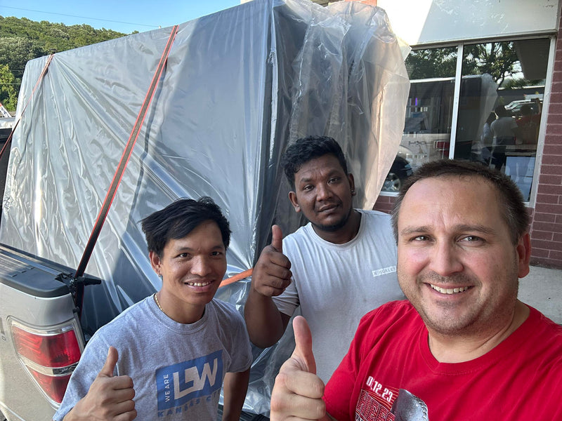 Happy customers giving thumbs up with their mattress purchase and taking home same day