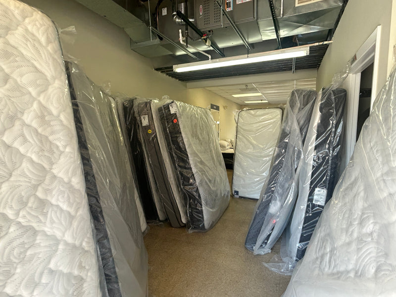 Factory Direct Mattress KCK storage room with mattress inventory