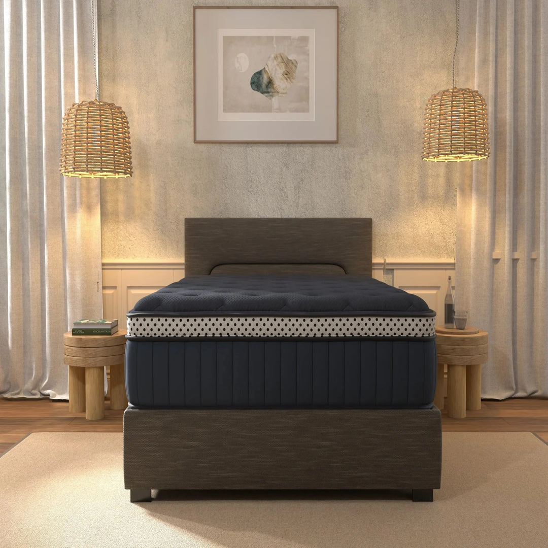 Navy mattress on a wooden bed frame in a bedroom setting with lamps and decor.