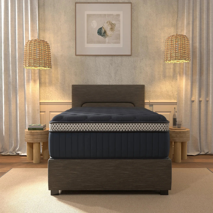 Navy mattress on a wooden bed frame in a bedroom setting with lamps and decor.