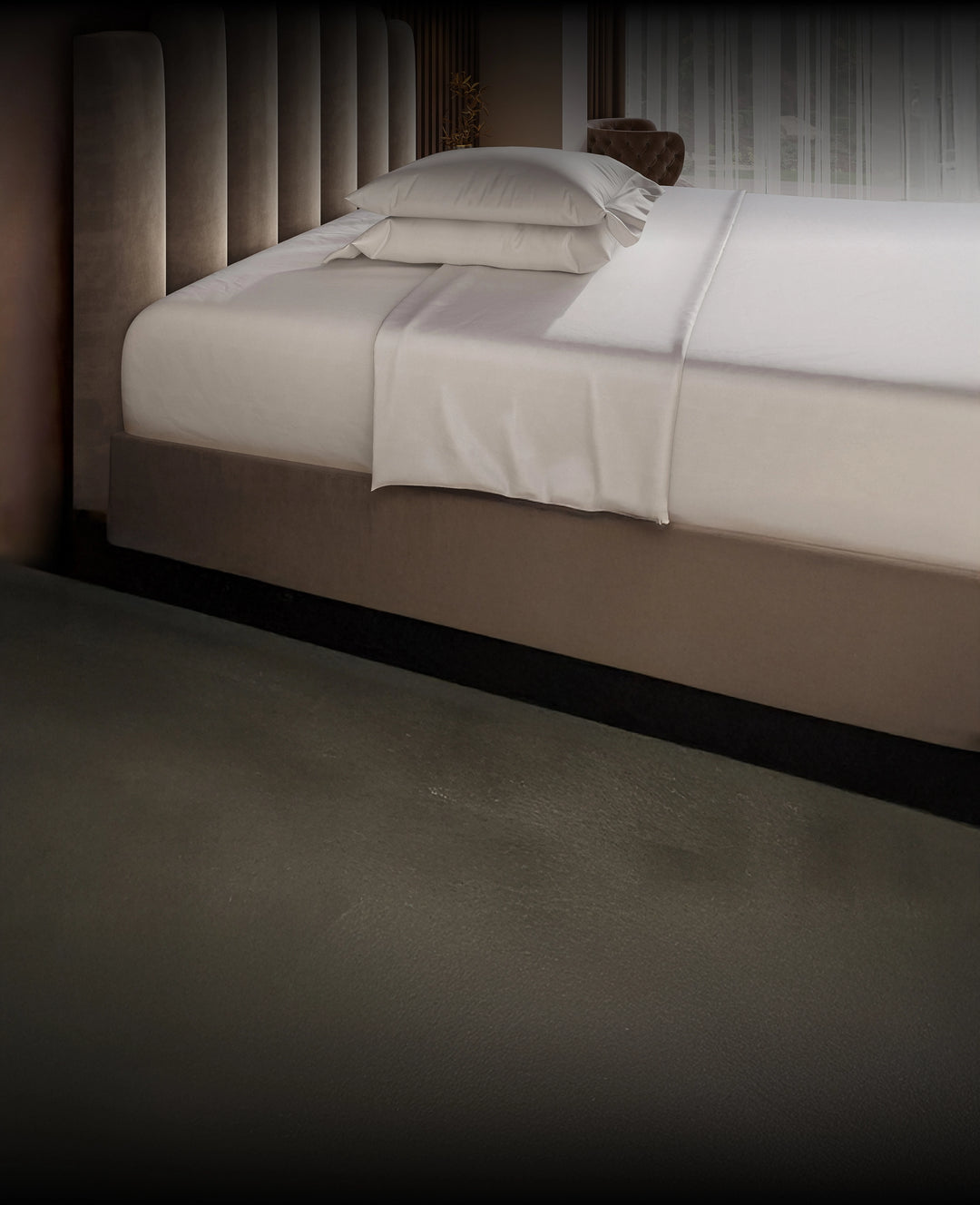 Neatly made Puffy Mattress with white bedding in a dimly lit room